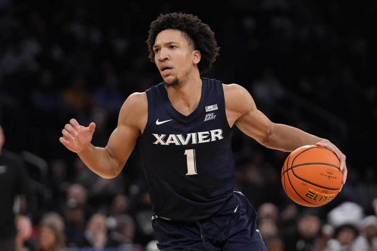 Xavier point guard Desmond Claude controls the ball during a game.