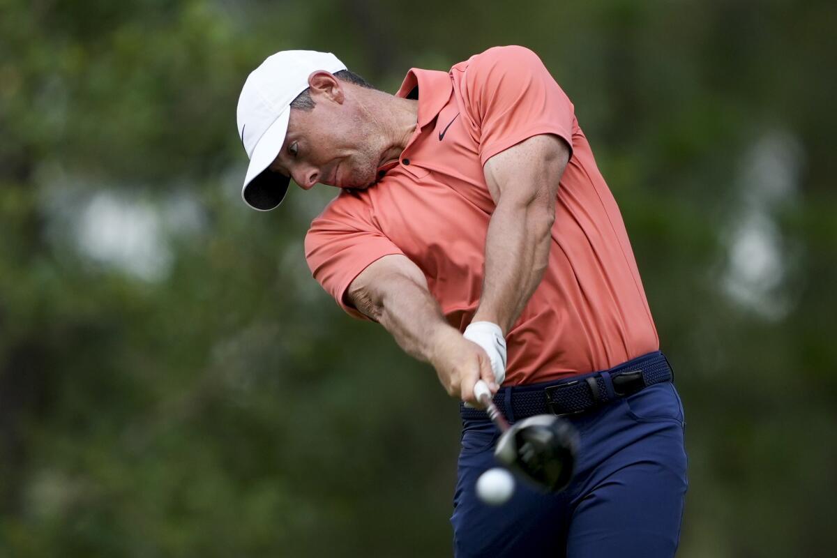 Rory McIlroy, of Northern Ireland, hits his tee shot on the 11th hole during the first round.