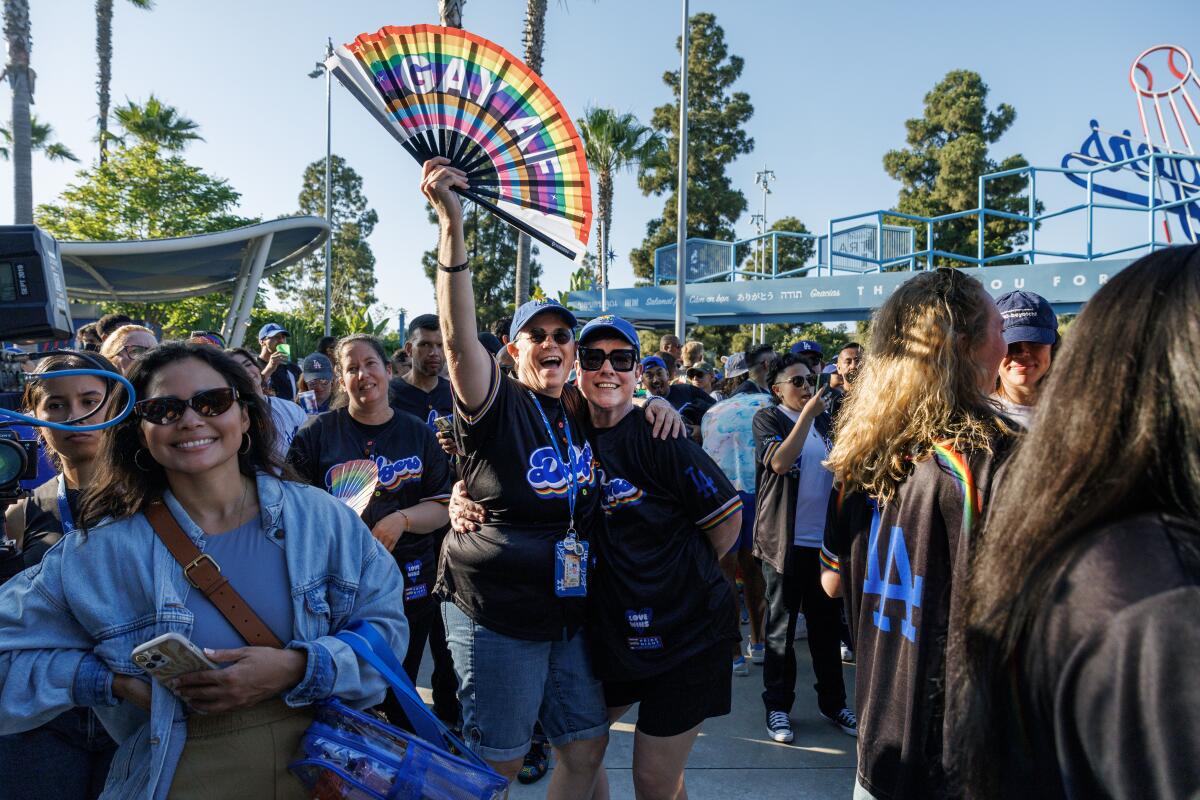 Dodgers fans Denise, left, and Colleen Quinn-Allen enjoy Pride Night at Dodger Stadium.