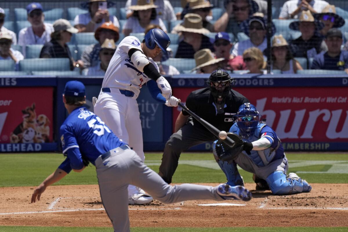 Shohei Ohtani hits a solo home run off Royals pitcher Brady Singer in the third inning Sunday at Dodger Stadium.