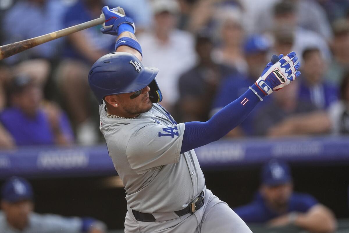 Dodgers shortstop Miguel Rojas singles during the third inning against the Colorado Rockies on Monday.