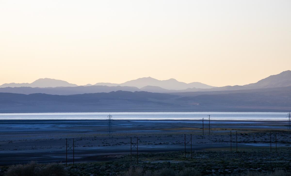 Mountains rise behind a bright blue lake.