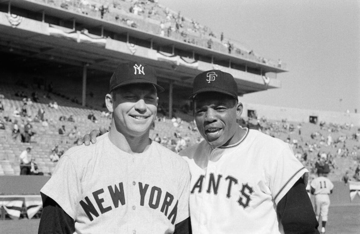 Willie Mays with arm around Mickey Mantle.