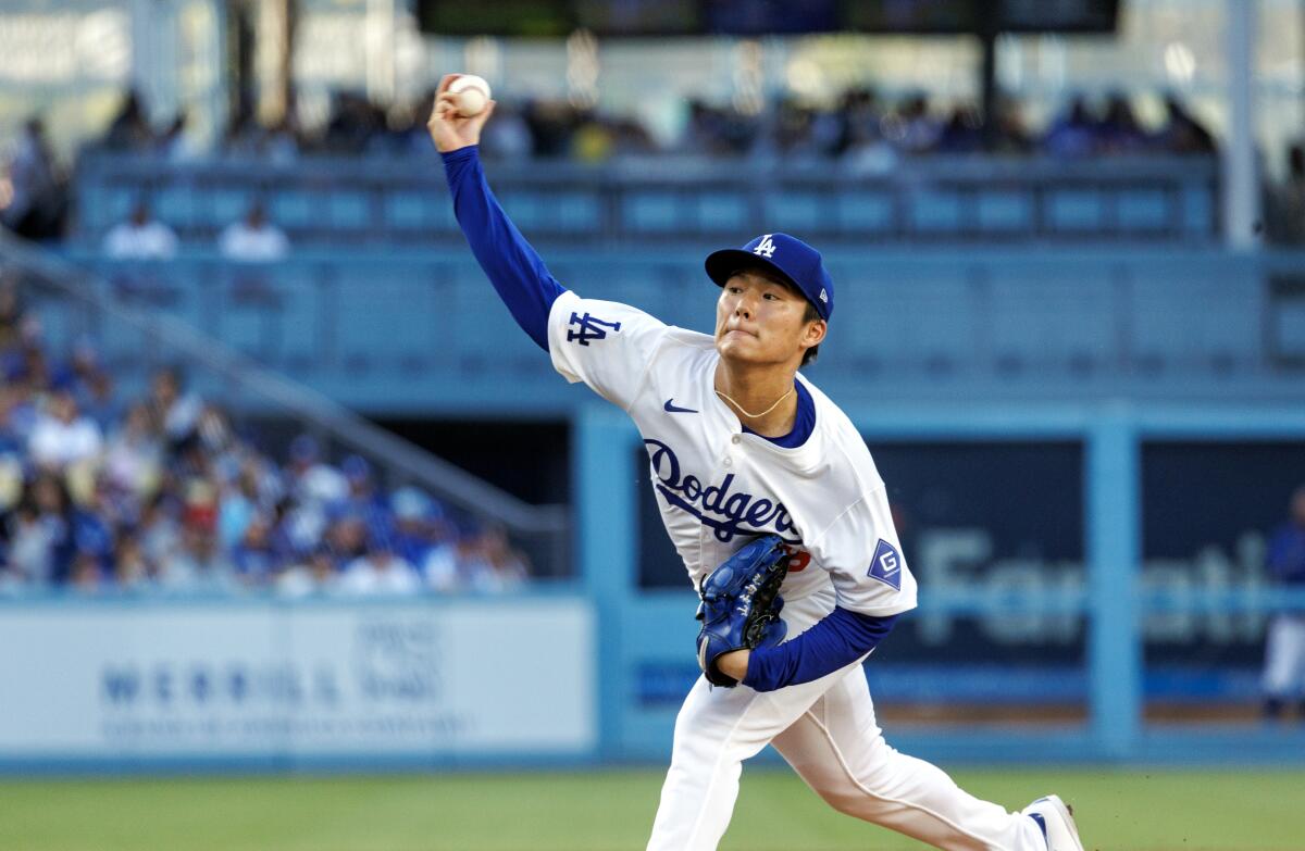 Dodgers right-hander Yoshinobu Yamamoto pitches in a home uniform at Dodger Stadium