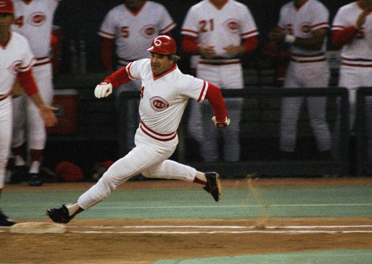 Reds' Pete Rose rounds first base after hitting a single to break Ty Cobb's record for career hits