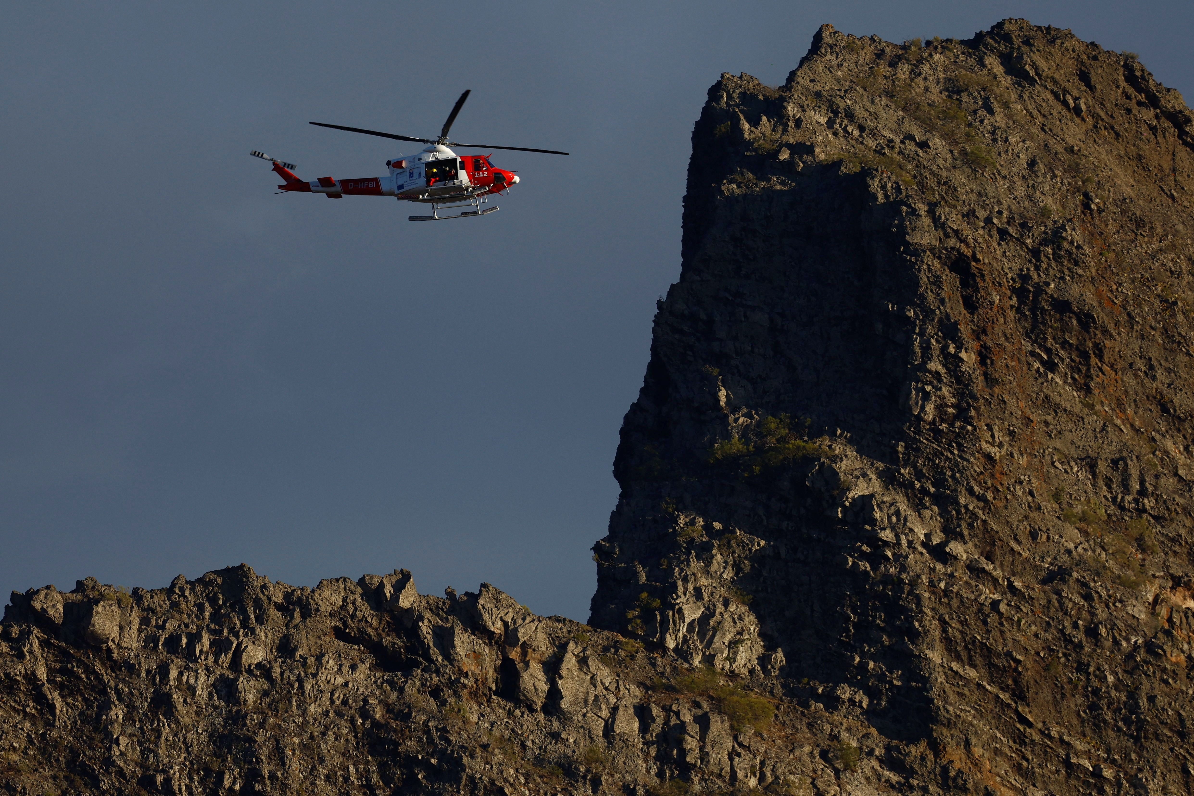 A rescue helicopter searches in the Masca ravine