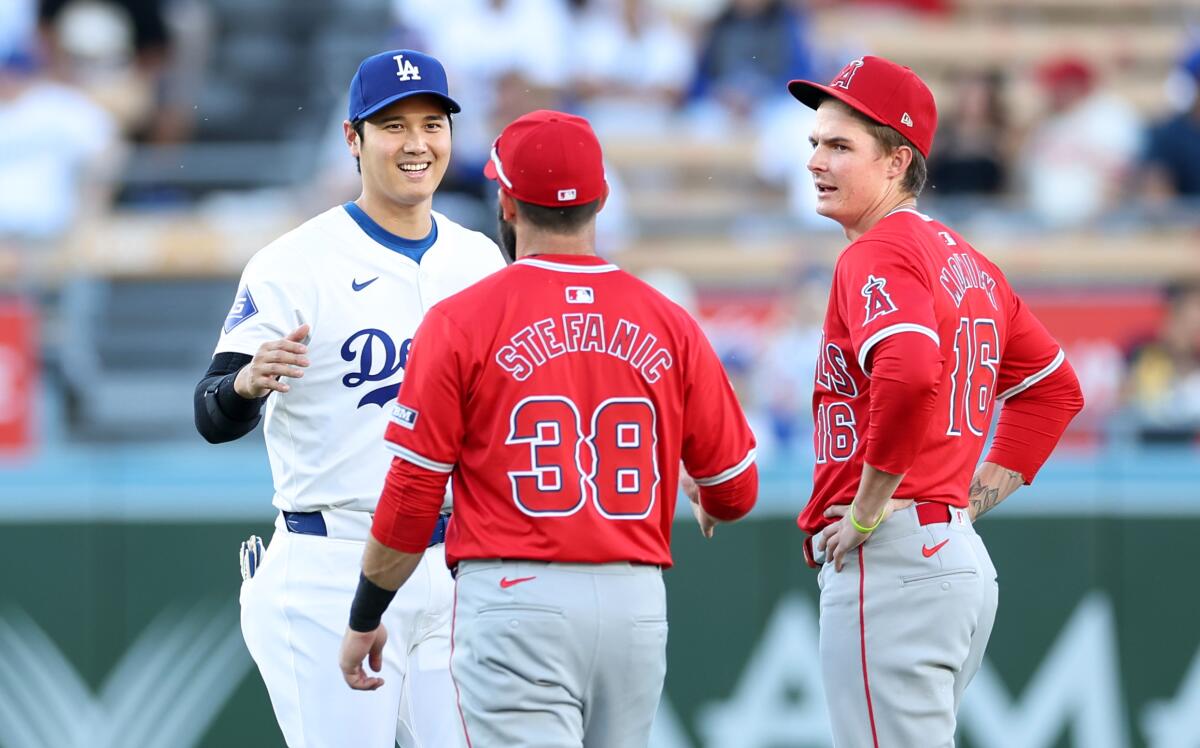 Dodgers star Shohei Ohtani greets the Angels' Michael Stefanic and Mickey Moniak at Dodger Stadium on Friday.