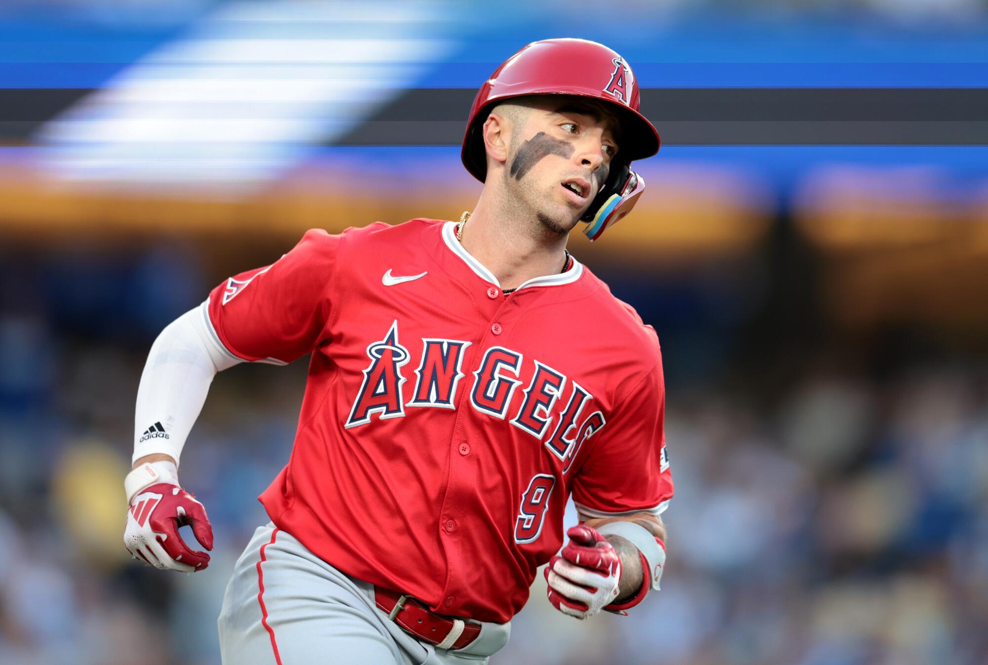 Zach Neto runs to first base against the Dodgers.