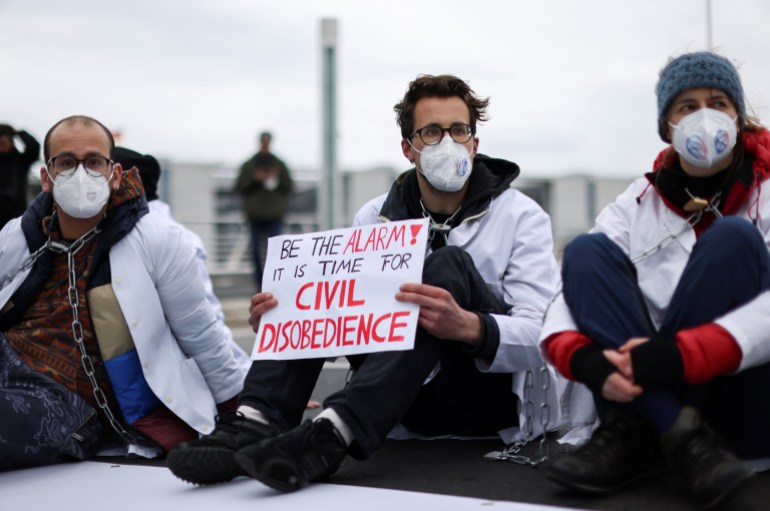 Activists from the Scientist Rebellion climate change group block a bridge in central Berlin, Germany, April 6, 2022. REUTERS/Christian Mang