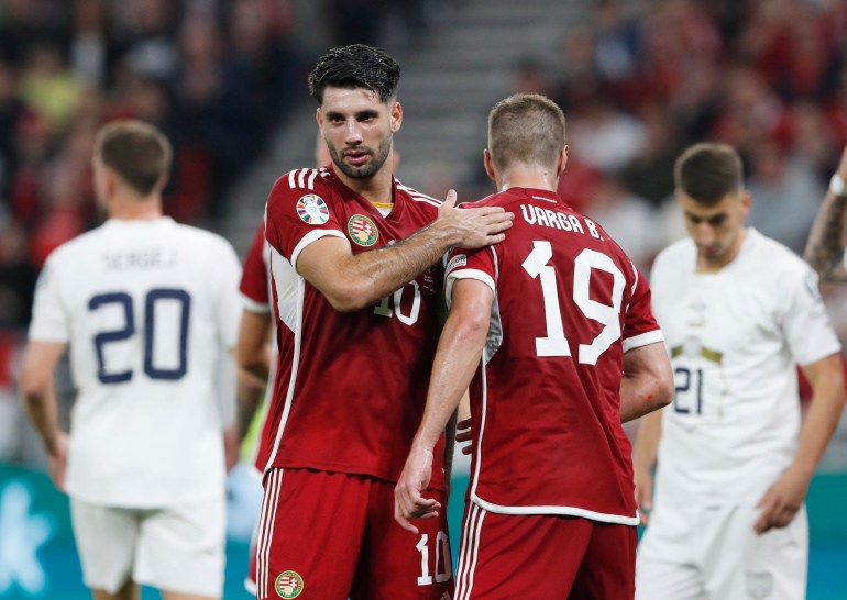 Two footballers embrace after match.