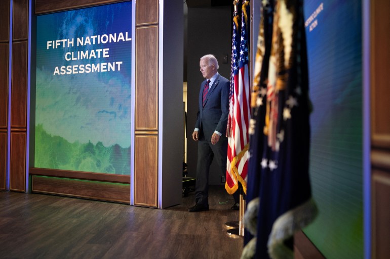 US President Joe Biden walks to a podium to talk about an initiative to tackle climate change