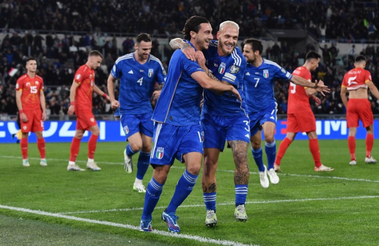 Football players celebrate goal.