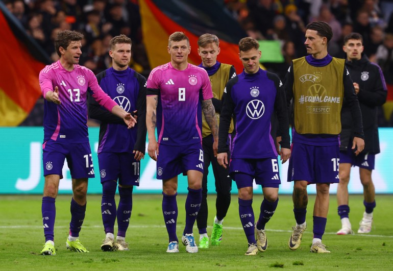 Football players walking off pitch.