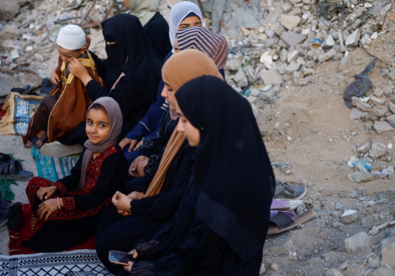 Palestinians hold Eid al-Adha prayers by the ruins of the Al-Rahma mosque destroyed by Israeli air strikes, amid the Israel-Hamas conflict, in Khan Younis, in the southern Gaza Strip, June 16, 2024. REUTERS/Mohammed Salem