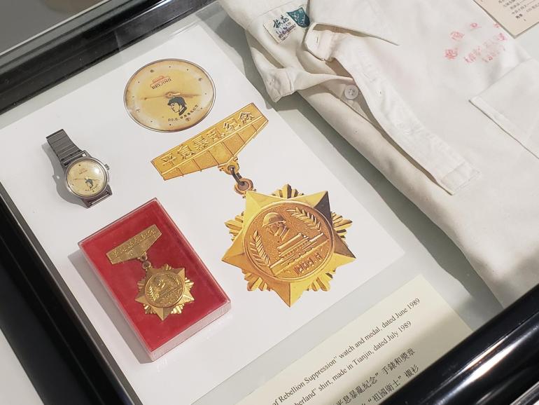 A 'suppression' medal given to the soldiers who took part in the crackdown, in a box along with its citation.