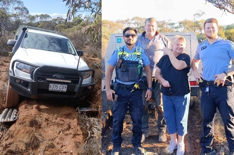 white car bogged in mud and four people - three men and one woman pose form a photo in scrubland