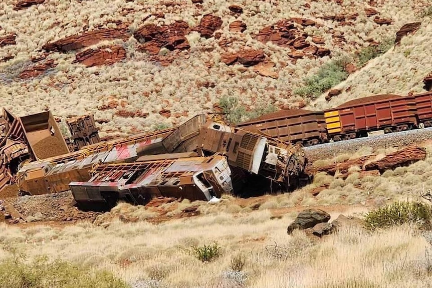 Overturned freight train carriages in the desert.