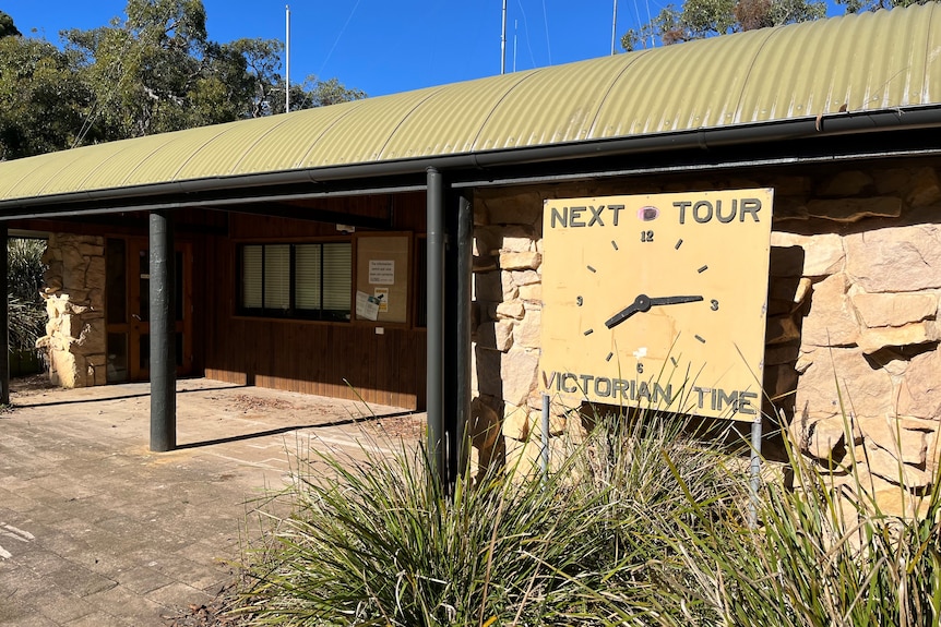 A building with a clock on it saying NEXT TOUR VICTORIAN TIME