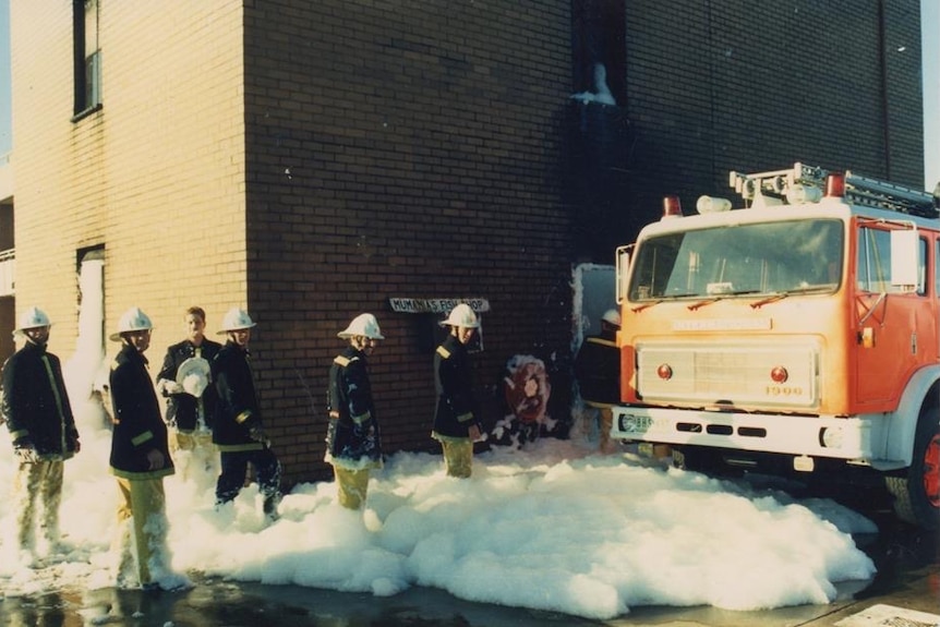 Firefighters using foam.