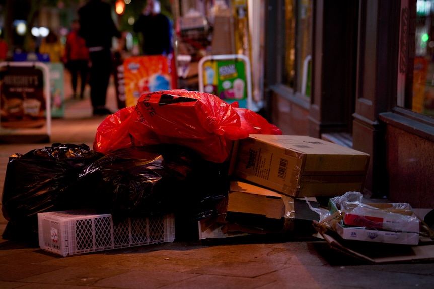 A pile of rubbish on a footpath.