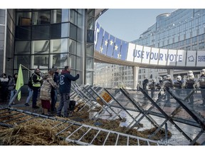 Farmers protest near dumped hay outside the European Parliament in Brussels, on Feb. 1. Photographer: Cyril Marcilhacy/Bloomberg