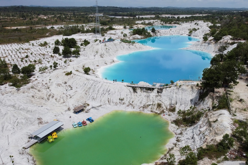 An aerial view shows a lake known as Kulong Biru formed by a flooded tin mine in Indonesia.