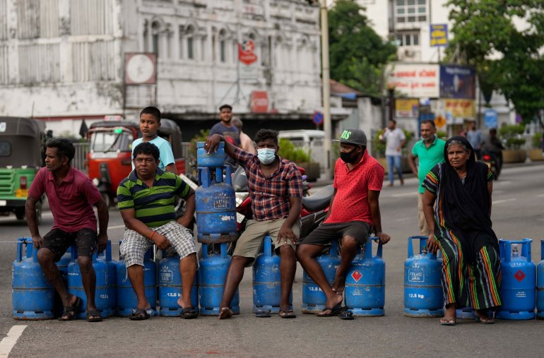 Sri Lankans block an intersection demanding cooking gas cylinders in Colombo, Sri Lanka, Saturday, May 7, 2022. Diplomats and rights groups expressed concern Saturday after Sri Lankan President Gotabaya Rajapaksa declared a state of emergency and police used force against peaceful protesters amid the country's worst economic crisis in recent memory. (AP Photo/Eranga Jayawardena)