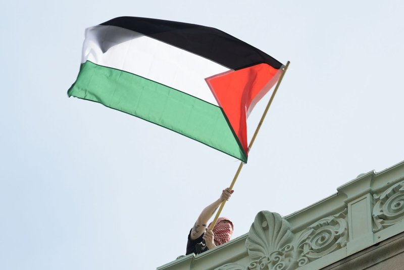 A student protester waves a Palestinian flag above Hamilton Hall on the campus of Columbia University in New York City on April 30. Armenia announced on Friday that it will recognize Palestine as a state. File Photo by Mary Altaffer/UPI