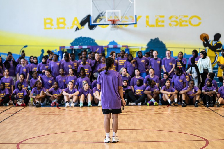 Basketball players in a group behind the court