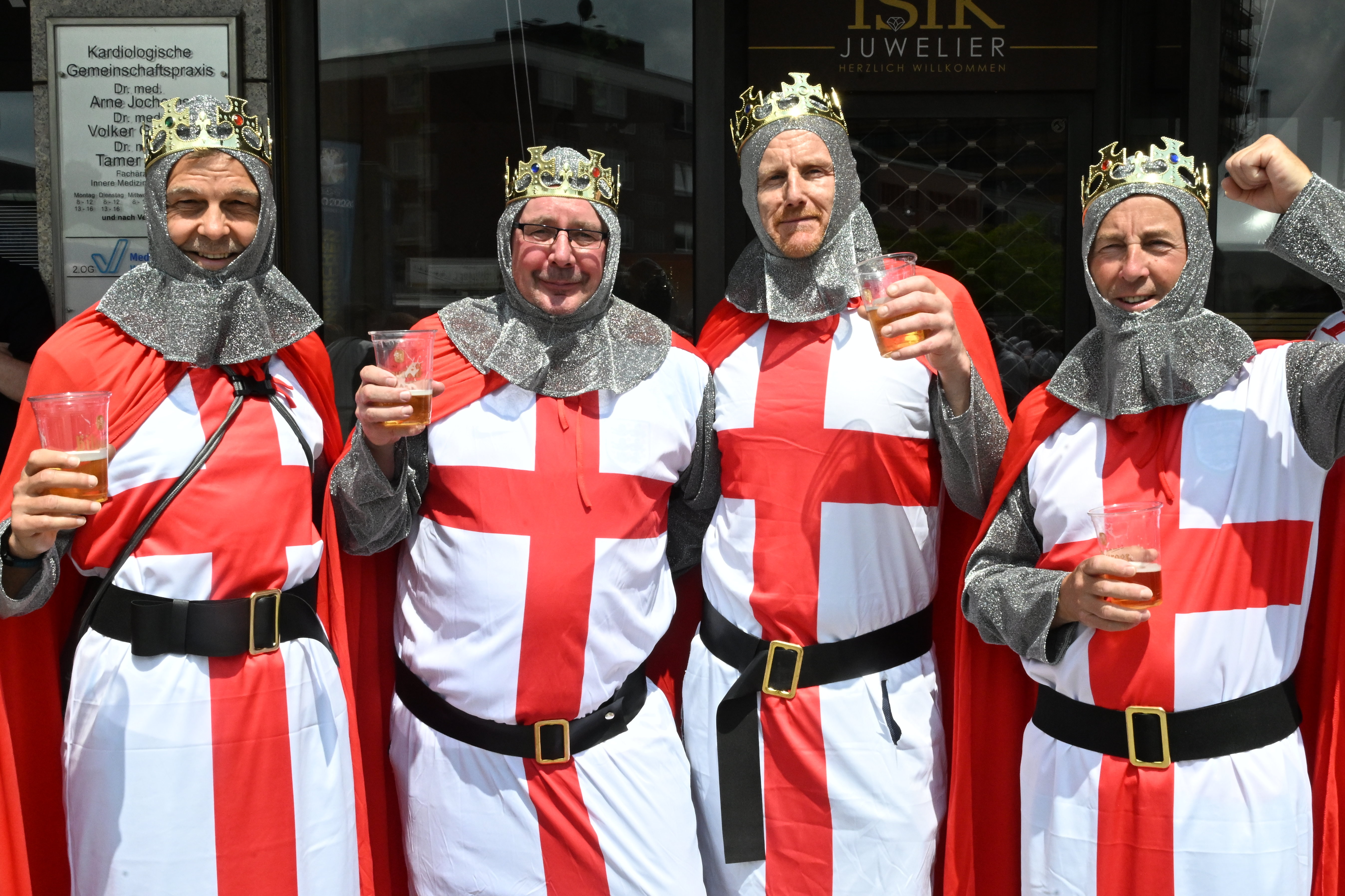 Four England fans in St George costumes in Gelsenkirchen