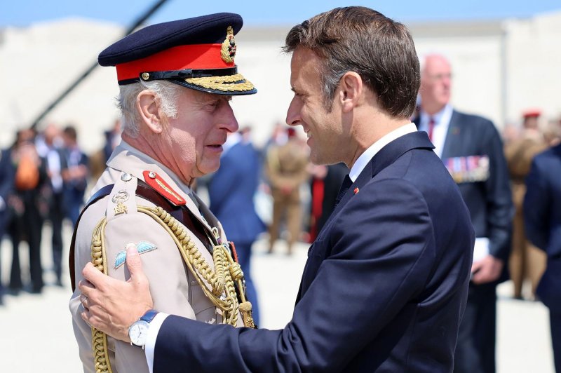France's President Emmanuel Macron greets Britain's King Charles III during the UK Ministry of Defence and the Royal British Legion's commemorative ceremony marking the 80th anniversary of the World War II "D-Day" Allied landings in Normandy, at the World War II British Normandy Memorial near the village of Ver-sur-Mer in northwestern France, on June 6, 2024. Photo by Embassy France in U.S/UPI