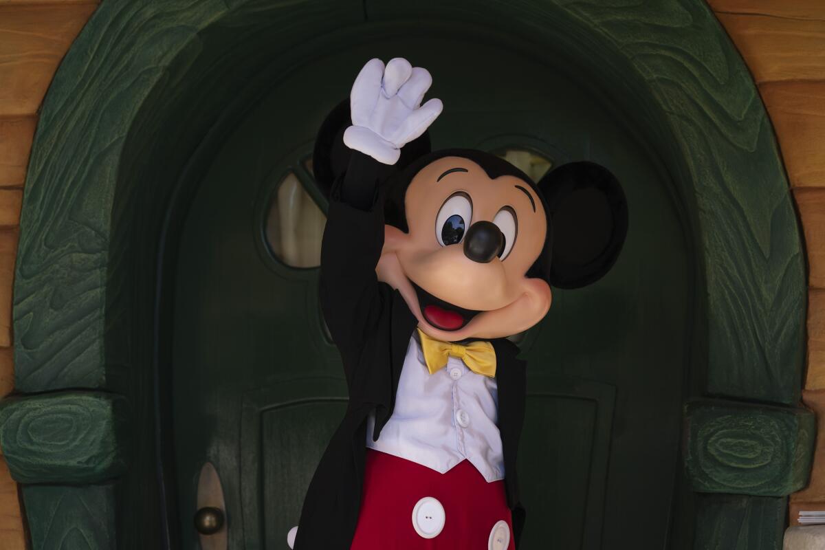 Mickey Mouse waves at Disneyland.