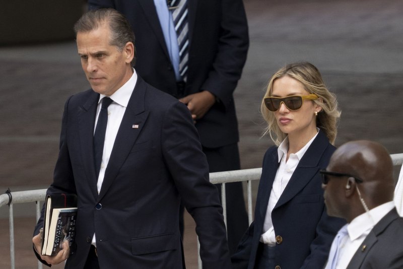 Hunter Biden (L), son of U.S. President Joe Biden, departs the J. Caleb Boggs Federal Building on Thursday with his wife, Melissa Cohen Biden (C), on the fourth day of trial on criminal gun charges in Wilmington, DE.Photo by Ken Cedeno/UPI