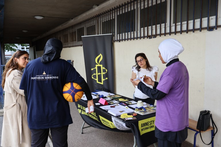 Amnesty International desk at basketball tournament.