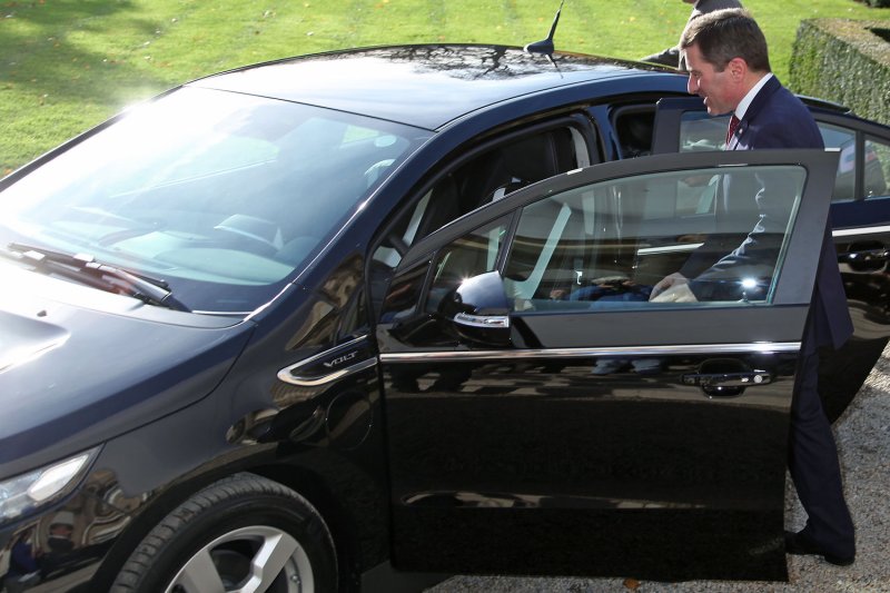 U.S. Ambassador Charles Rivkin gets into a new Chevrolet Volt in Paris in 2011, when it was introduced there. GM is lowering its 2024 EV production target due to low consumer demand. File Photo by David Silpa/UPI