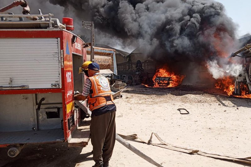 Firefighters put out a fire following a strike on the Al-Mawasi area northwest of Rafah. Photo by Palestinian Civil Defense/UPI