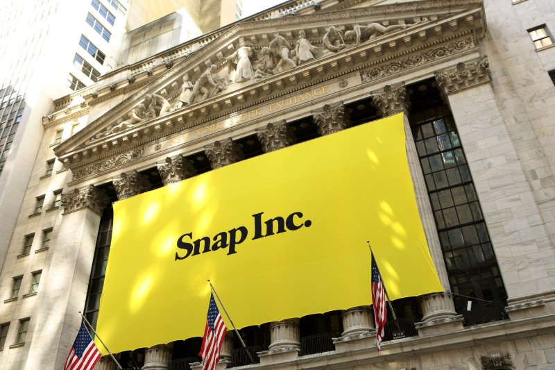 A banner advertising Snap hangs from the facade of the New York Stock Exchange as Snap's initial public offering debuts in New York City on March 2, 2017. Snap settled a sex employment discrimination lawsuit in California on Wednesday for $14 million. File Photo by Monika Graff/UPI