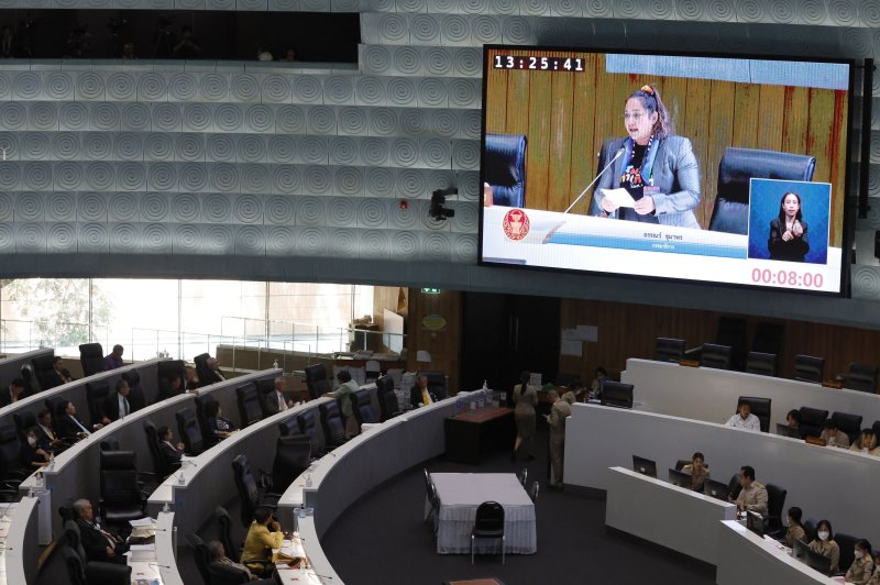 LGBTQ activist Ann Chumaporn (on large screen) addresses the floor of the Thai Senate on Tuesday ahead of a historic vote approving same-sex marriage legislation. Photo by Narong Sangnak/EPA-EFE