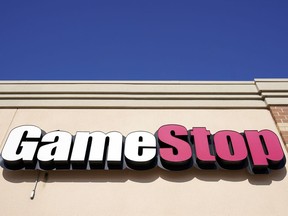 FILE - A GameStop sign is displayed above a store in Urbandale, Iowa, on Jan. 28, 2021. GameStop managed to narrow its losses in the first quarter, but the video game retailer's revenue fell as sales weakened for hardware and accessories, software and collectibles. The results were released shortly after the man at the center of the pandemic meme stock craze, who is known as "Roaring Kitty" on social media platforms YouTube and X, disclosed that he'll be hosting a YouTube livestream on Friday June 7, 2024.