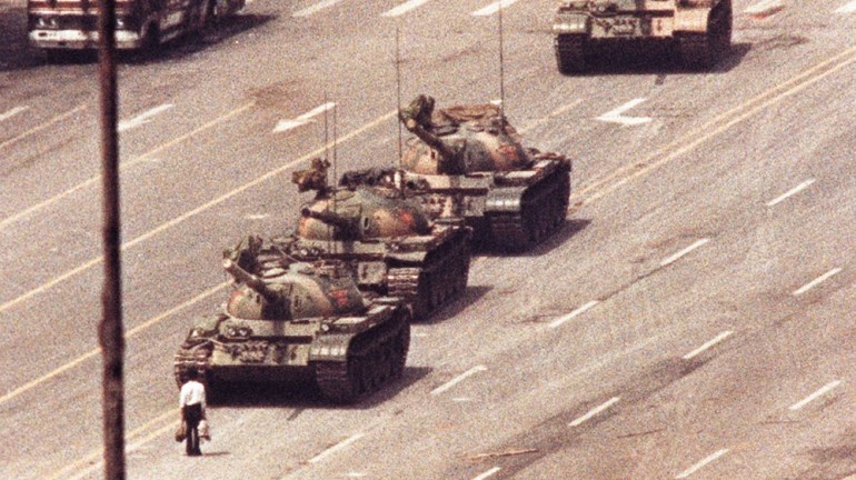 File photo of a man standing in front of a convoy of tanks in the Avenue of Eternal Peace in Tiananmen Square in Beijing