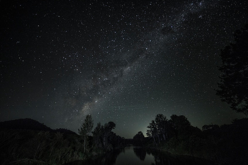 Millions of stars shine in a dark sky over the Sunshine Coast HInterland.