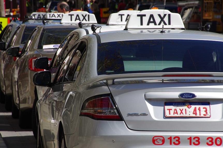 Silver taxi's lining up in row in Perth