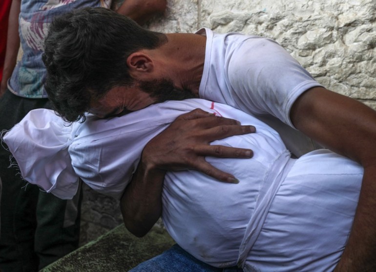 epaselect epa11484954 A Palestinian father mourns over the covered body of his daughter in the Al Aqsa hospital in Deir al Balah prior to burial, following an Israeli air strike in the Al Zwaida neighbourhood in the central Gaza Strip, 18 July 2024. According to a report from the Ministry of Health in Gaza, six Palestinians, members of the Muheisen family, were killed following an Israeli air strike in the Central Gaza Strip. More than 38,000 Palestinians and over 1,400 Israelis have been killed, according to the Palestinian Health Ministry and the Israel Defense Forces (IDF), since Hamas militants launched an attack against Israel from the Gaza Strip on 07 October 2023, and the Israeli operations in Gaza and the West Bank which followed it. EPA-EFE/MOHAMMED SABER