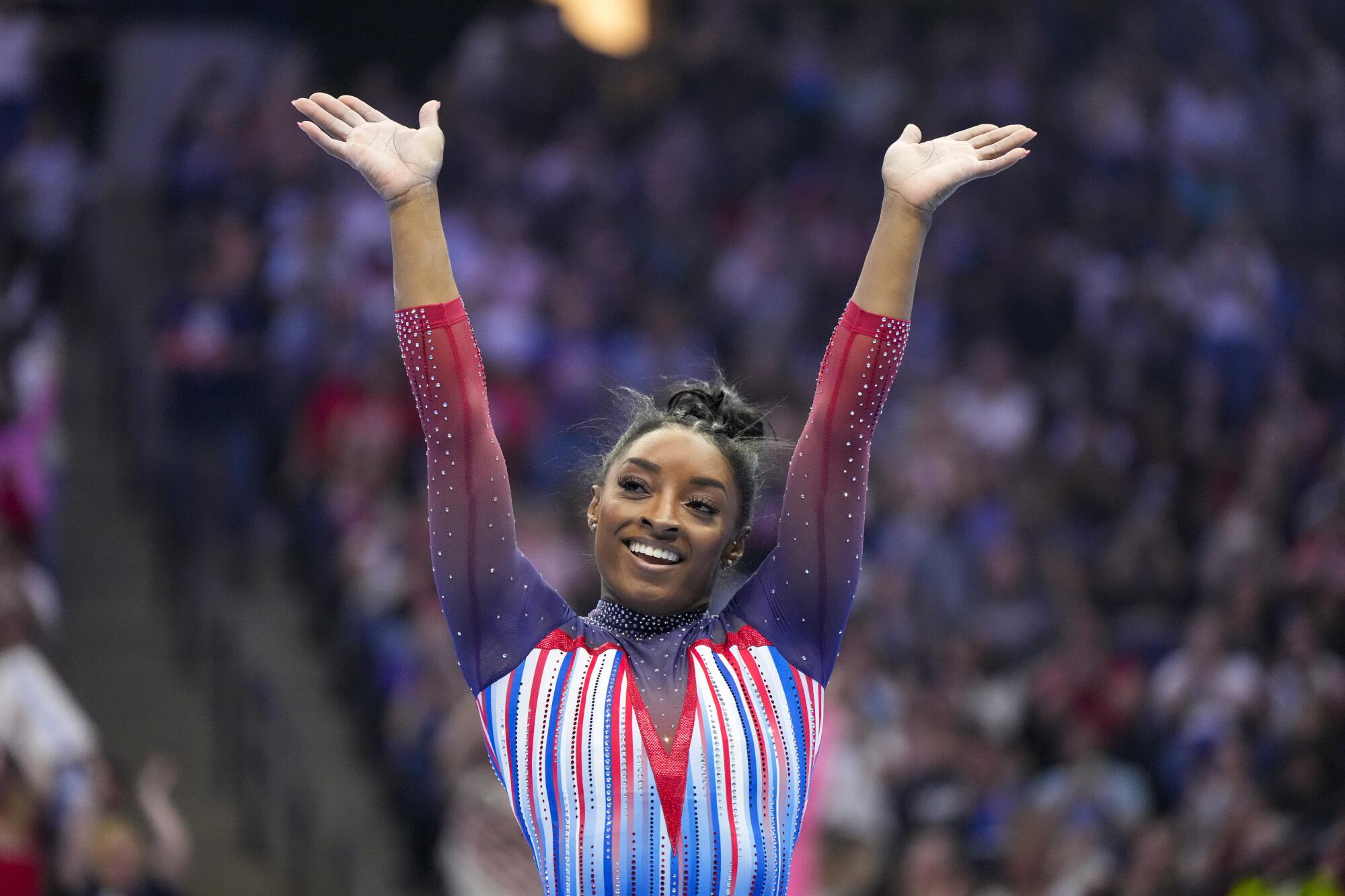 Simone Biles smiles after competing in the floor exercise Sunday.