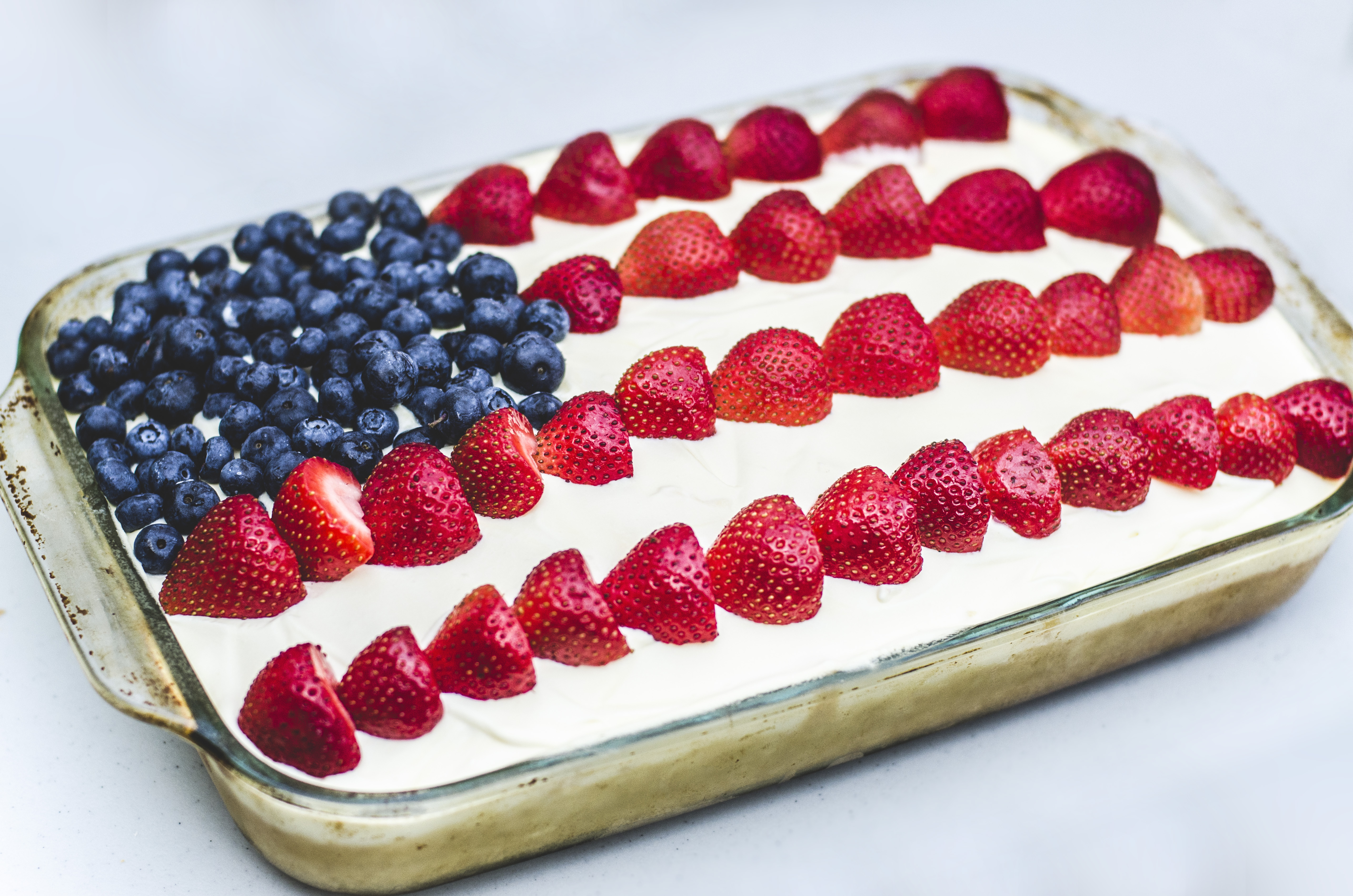 They decorated the pre-made sheet cake in the shape of an American Flag with fruit (Stock photo)