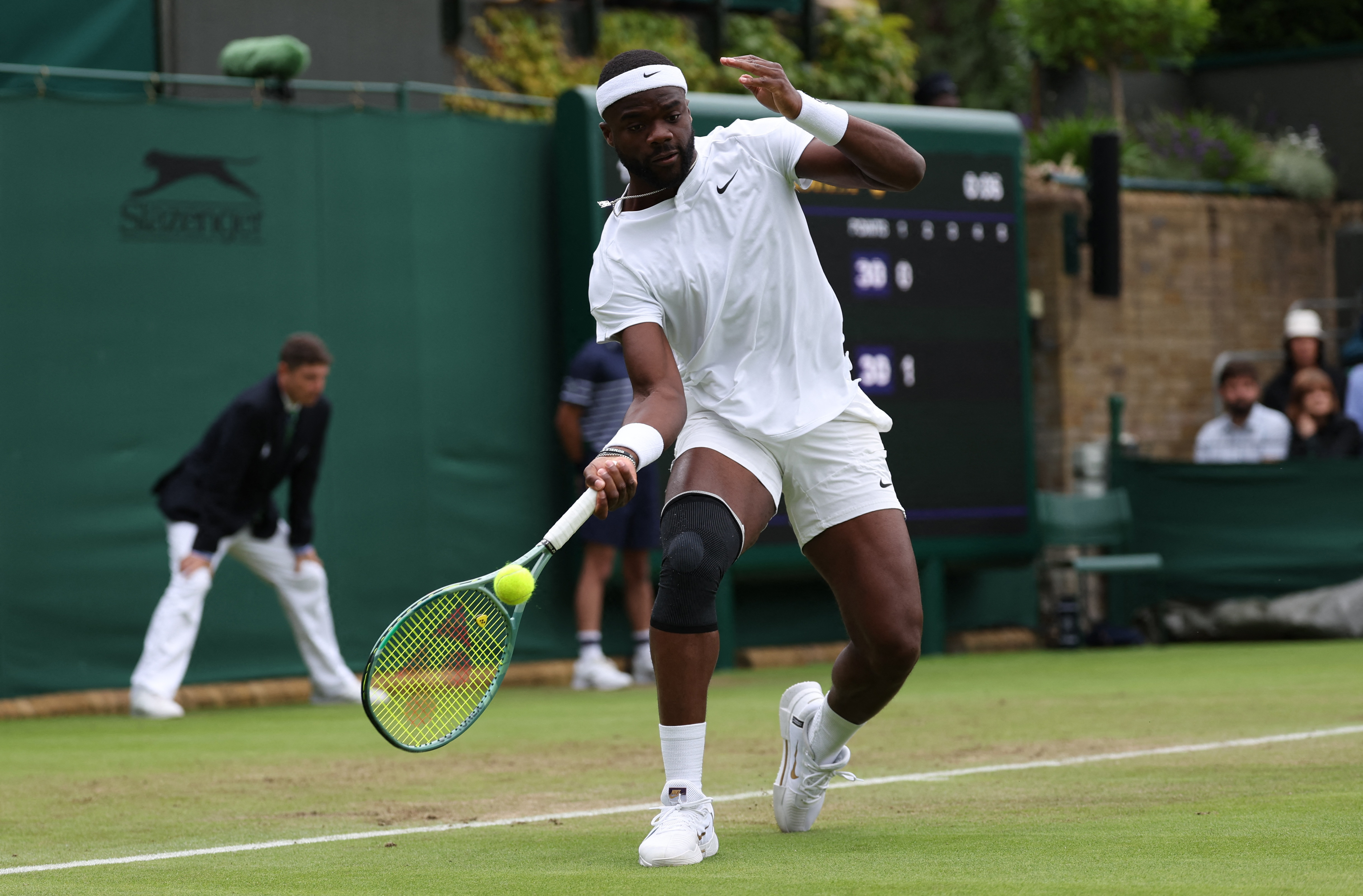 Frances Tiafoe is wearing a black knee support