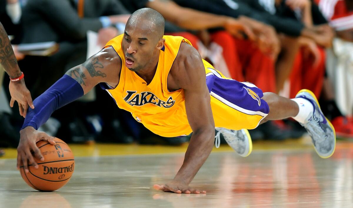 Lakers guard Kobe Bryant dives for a loose ball during a 2013 game against the Bucks