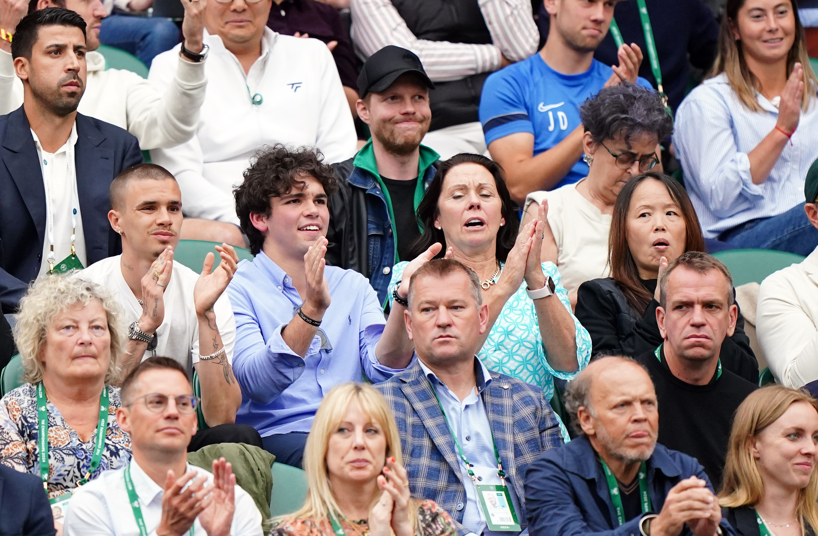 Emma's mum Renee Zhai (right) seated near Romeo Beckham (left) during her match against Elise Mertens on day three