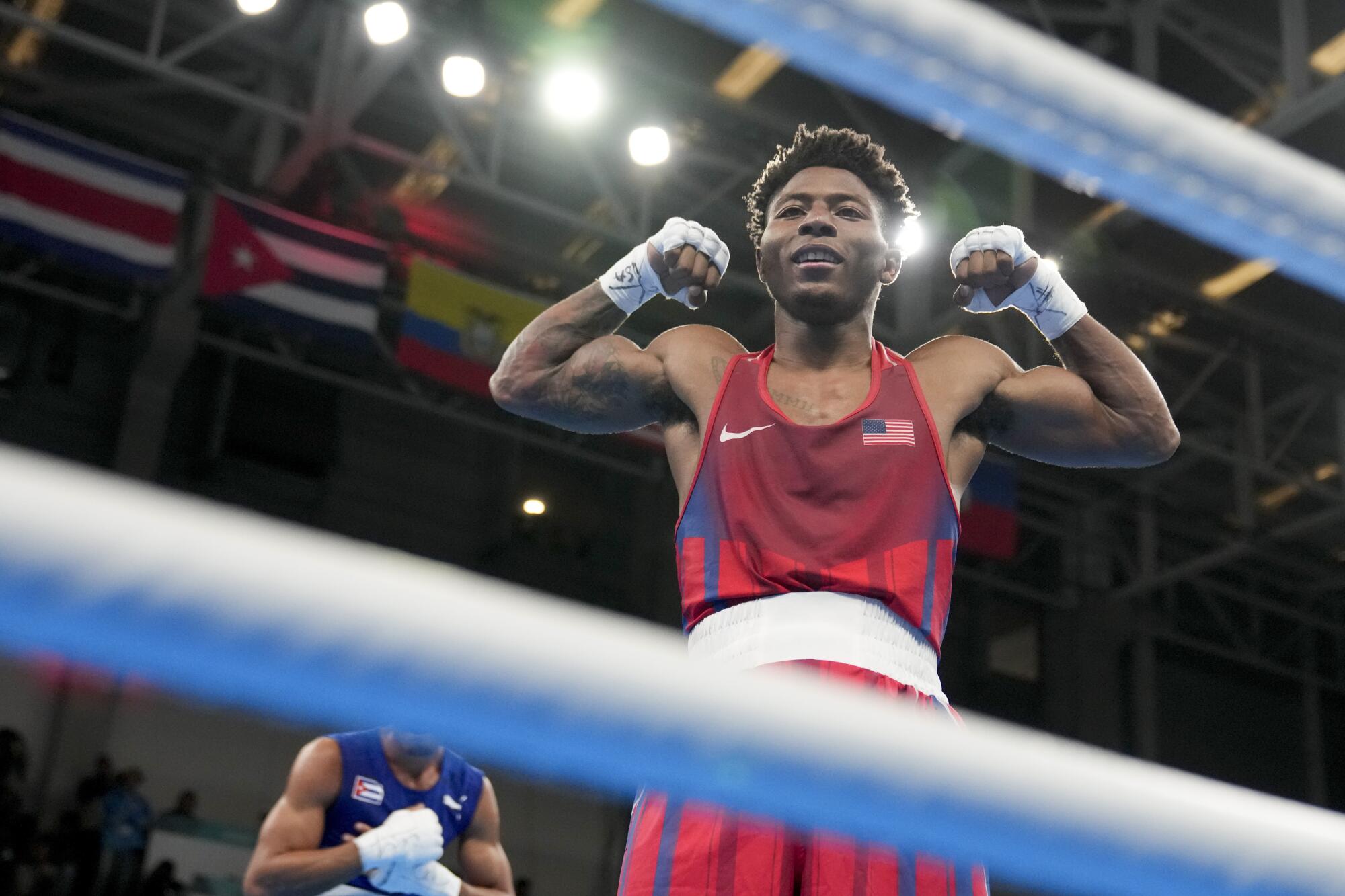 Jahmal Harvey celebrates after defeating Cuba's Saidel Horta in the men's 57-kilogram final at the Pan American Games.