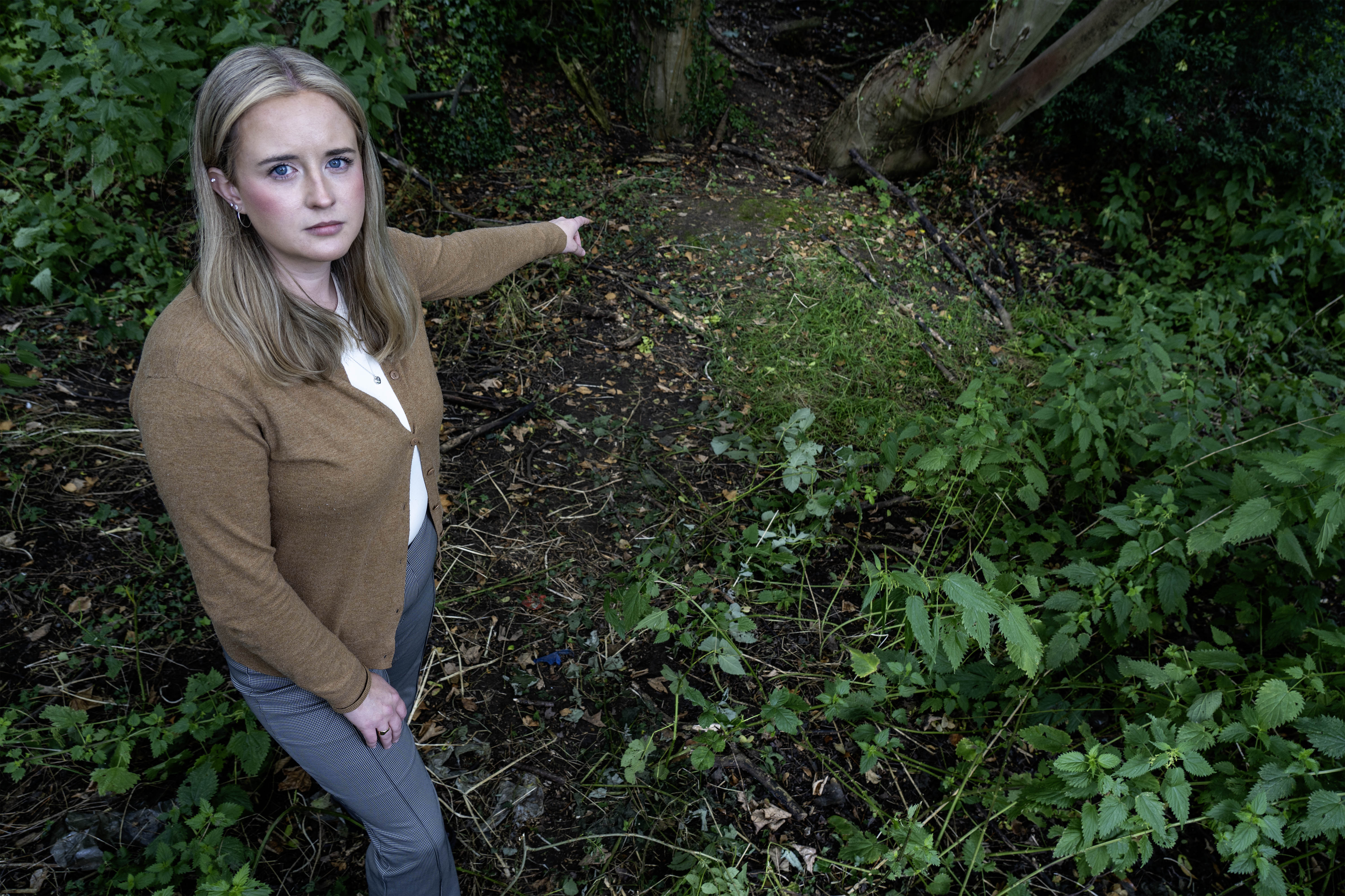 Sun reporter Emily-Jane Heap pointing to Clifford's woodland  hideout